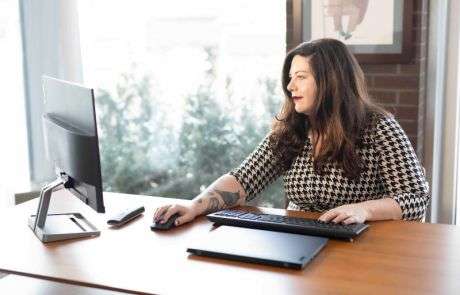 Erin working at her desk on her computer
