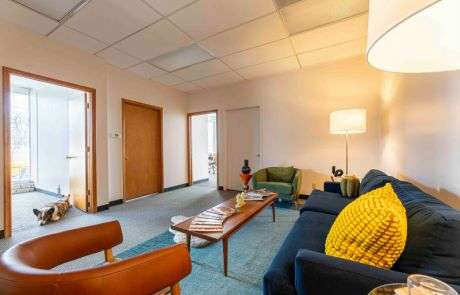 Erin's office waiting room with Weezer the Corgi laying in the doorway