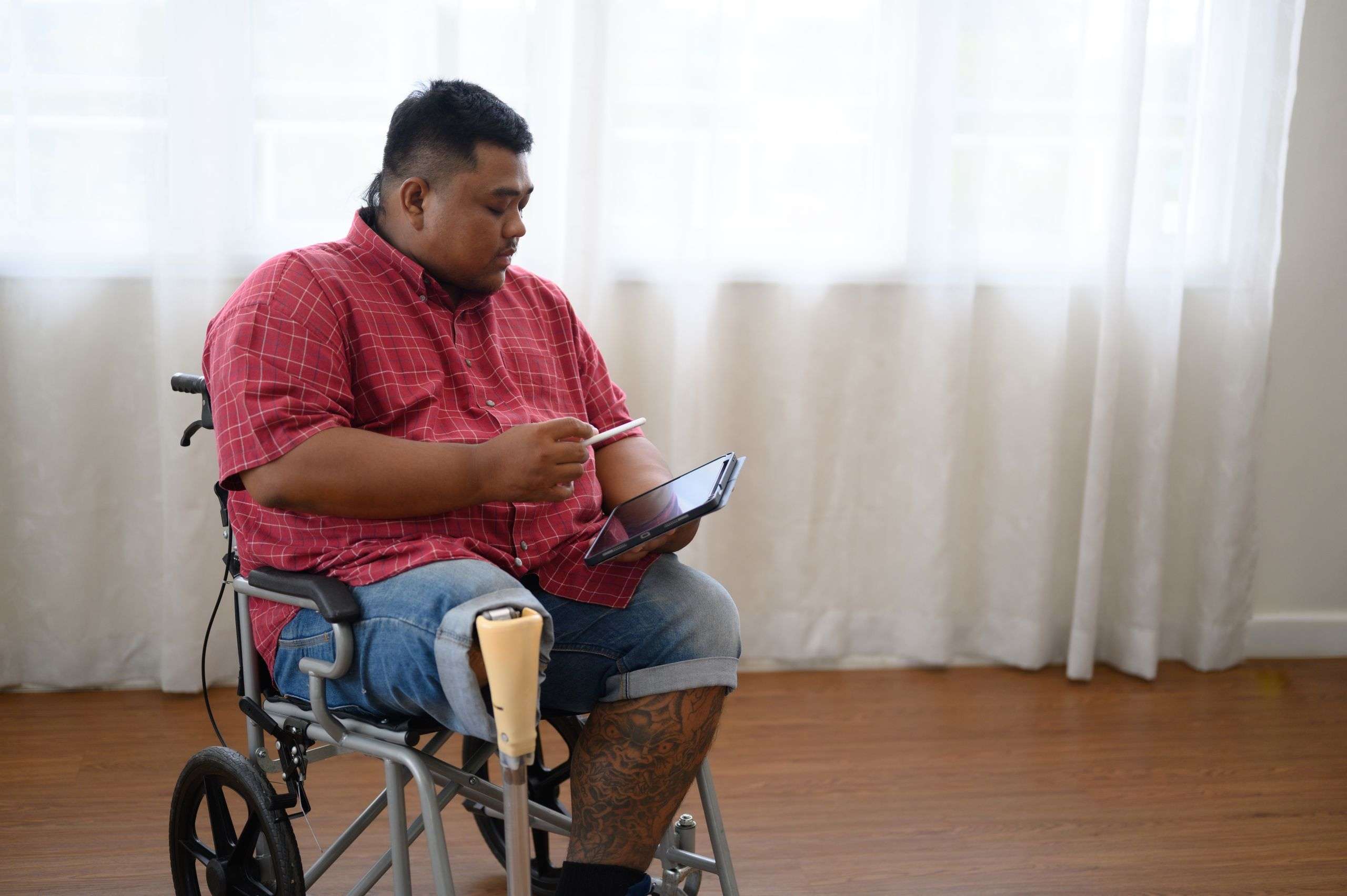 Amputee in a wheelchair using tablet