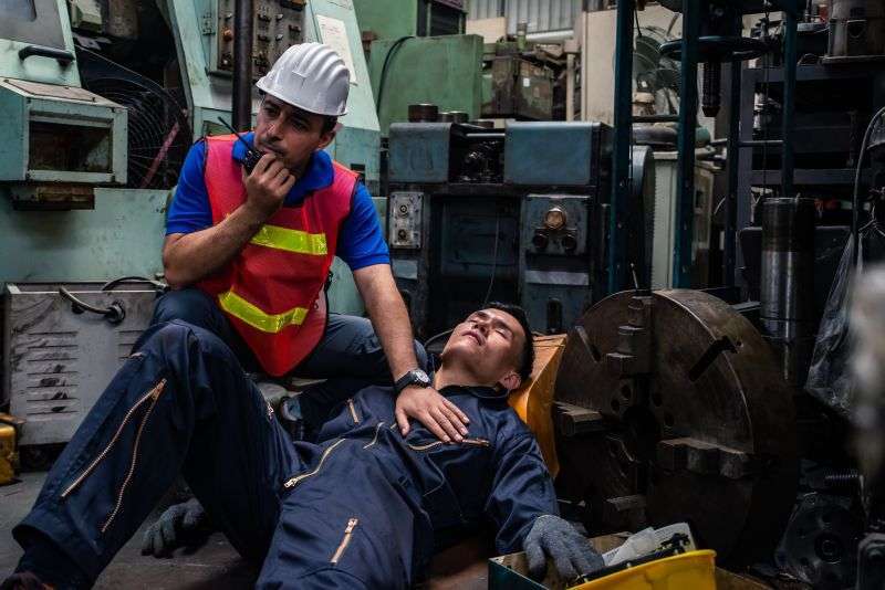 Unconscious worker on factory floor