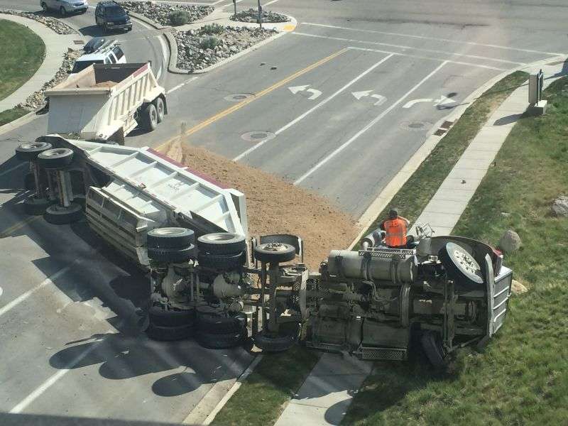Overturned truck on highway with spilled cargo